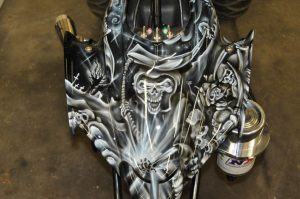 Skulls and skeletons are painted onto a front panel of an ATV