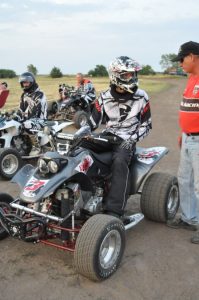 An ATV racer sits on the track waiting on the race to begin