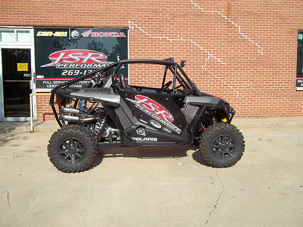 The JSR Performance UTV sits in front of the shop, with the side view